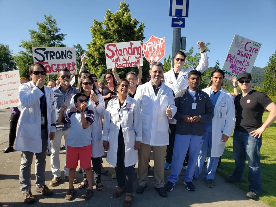 Group of hospitalists with signs