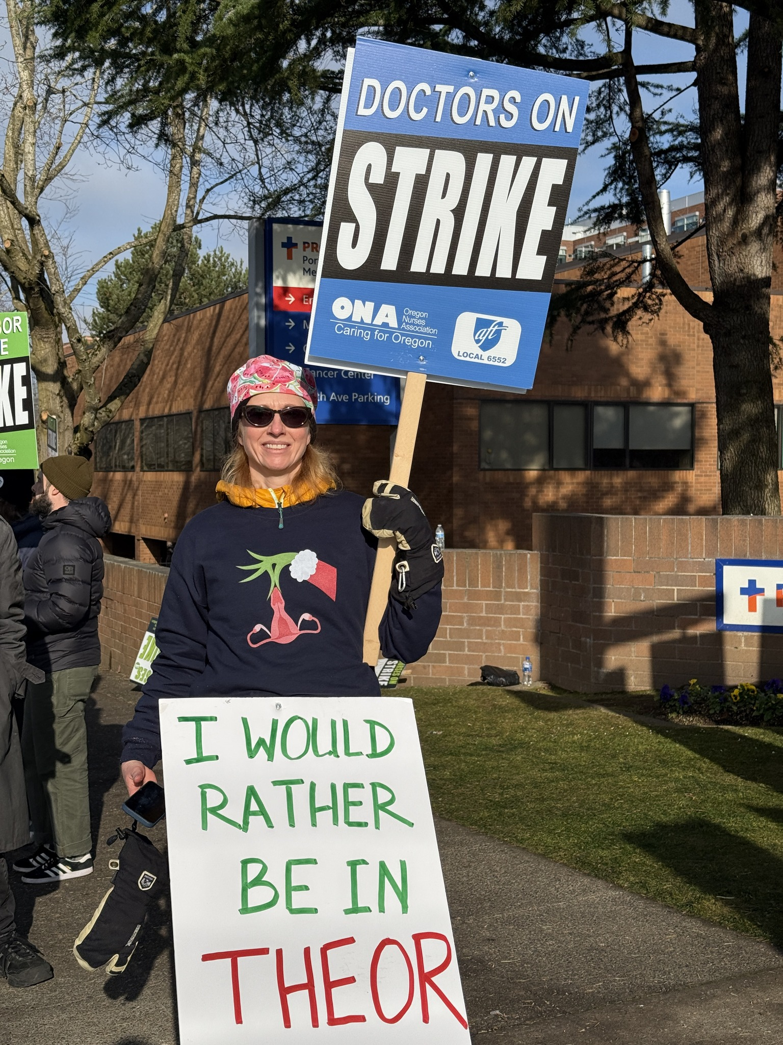 Hospitalist holding a strike sign