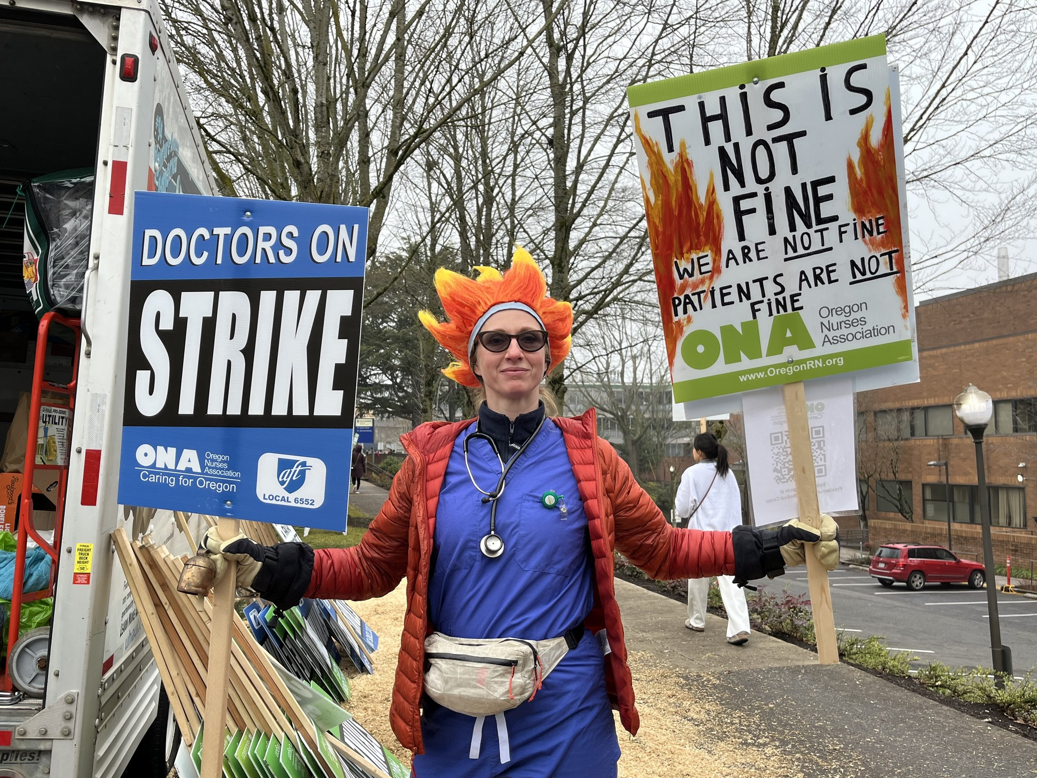 Hospitalist holding a strike sign