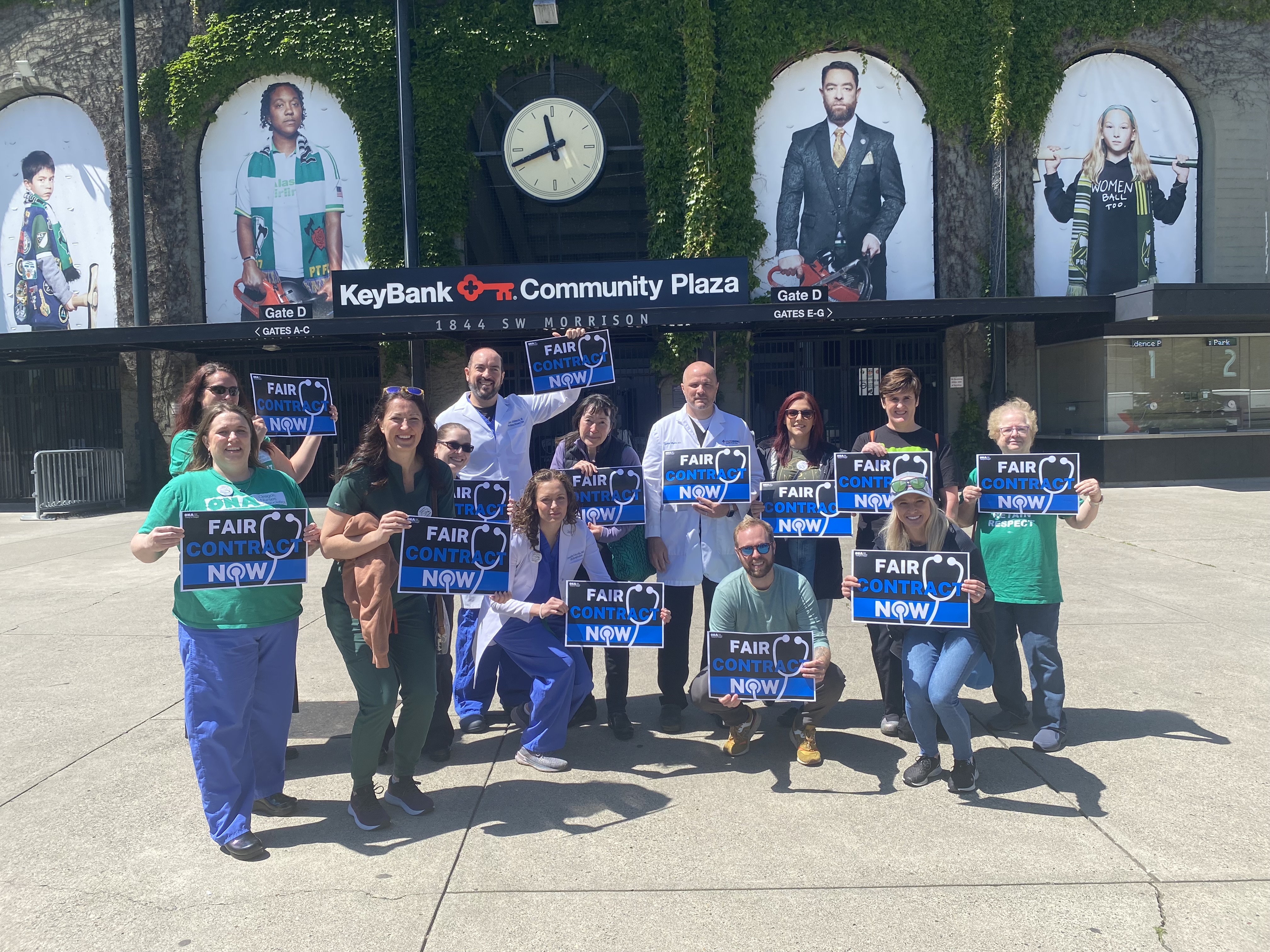 Group of hospitalists holding signs