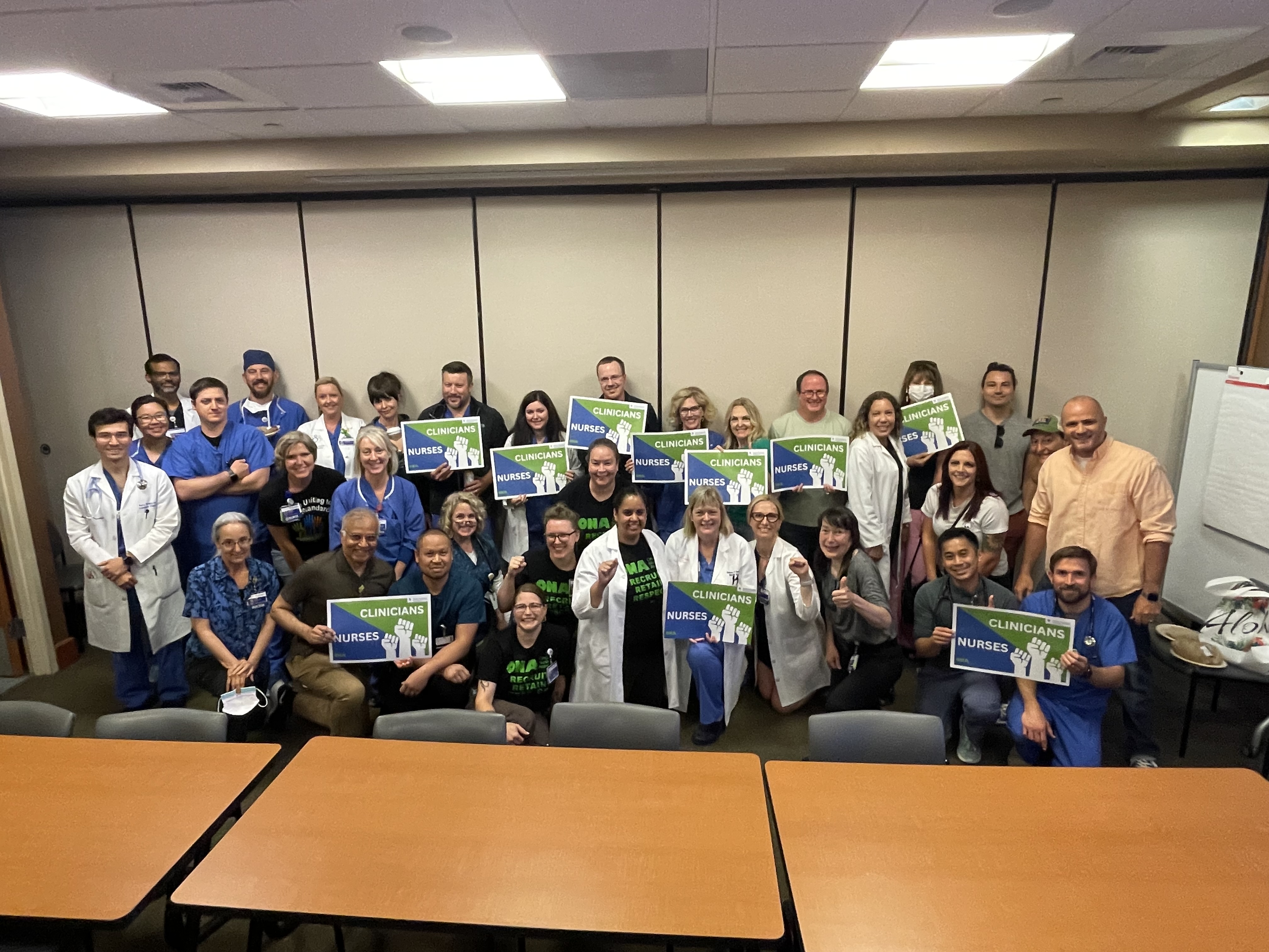 Group of hospitalists holding signs